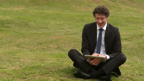 Handsome businessman using his tablet