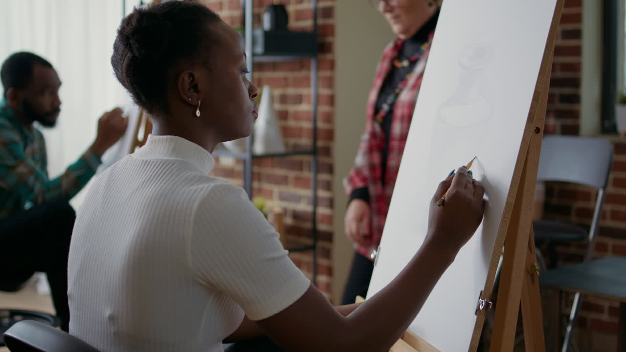 Young student creating vase masterpiece at art workshop