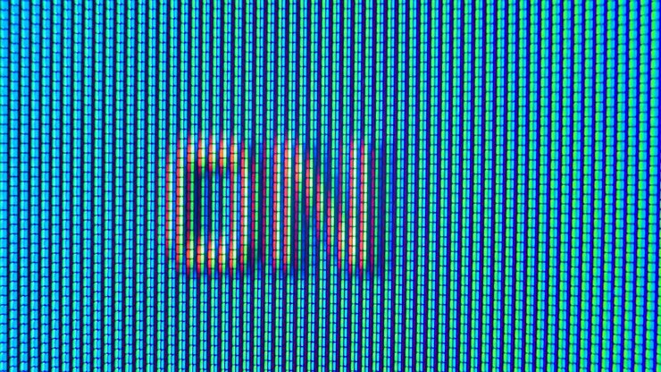 Pixels in the working old analog TV screen close up. Red, blue and green dot create the image on the screen. Analogue retro TV settings menu in extreme close up