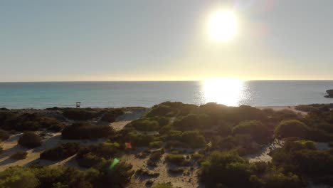 sunset beach aerial view with sand dunes and turquoise water