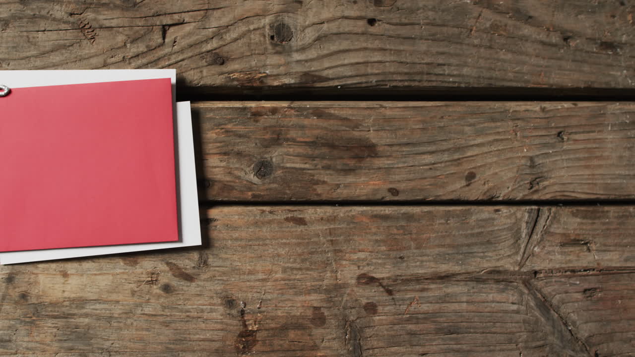 Video of christmas decorations with cards and copy space on wooden background