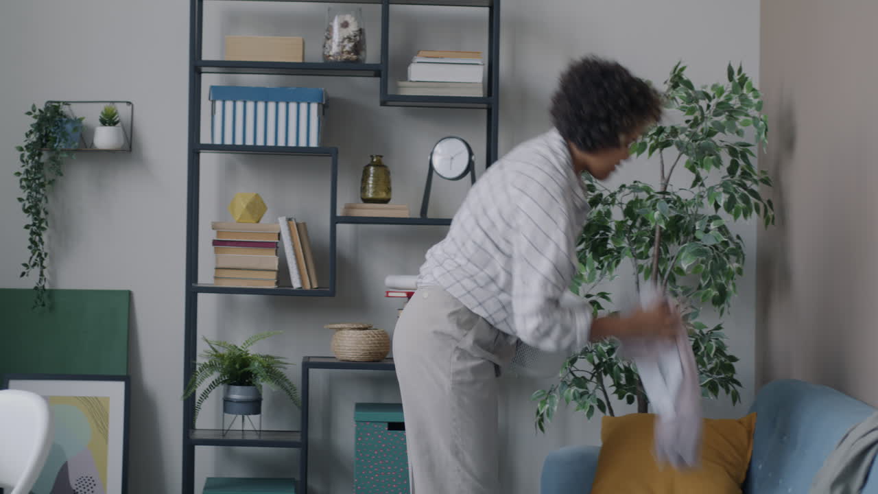 Woman Organizing Laundry Basket in Living Room