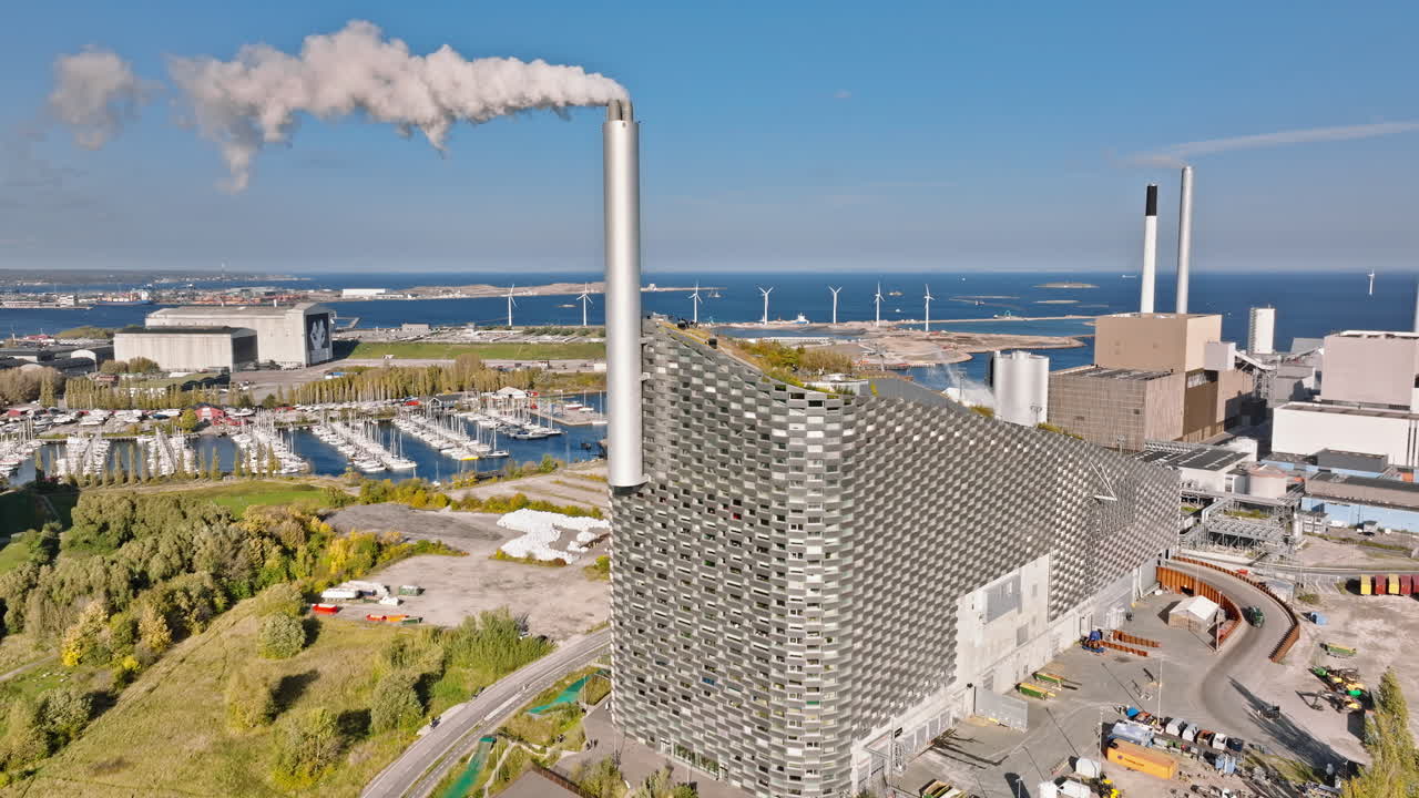 Aerial drone view of CopenHill artificial ski slope on the roof of an energy plant