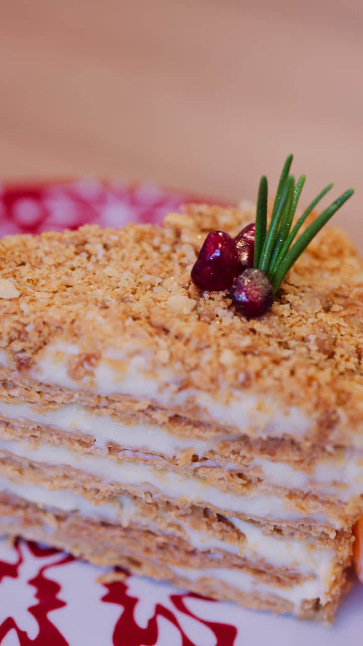 Close up of a slice of Medovik cake on a red and white plate