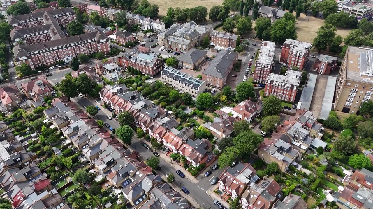 Case a schiera, palazzi signorili e alberi maturi riempiono un denso quartiere residenziale di Londra ovest accanto a un'area verde aperta e arida