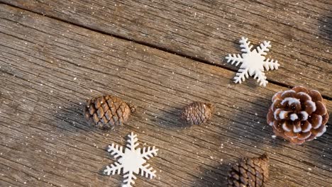 falling snow with christmas pine cone decoration