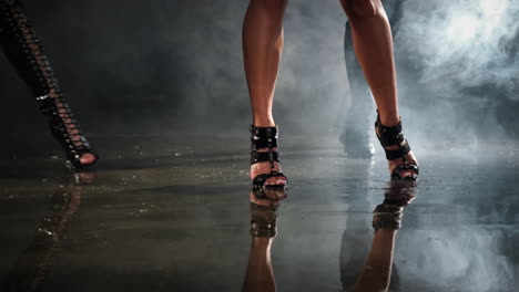 women in high heels on a wet floor