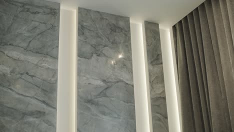 modern wall design with marble texture and vertical lighting