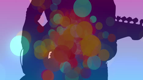 animación de puntos coloridos que se mueven sobre la silueta de un hombre tocando la guitarra
