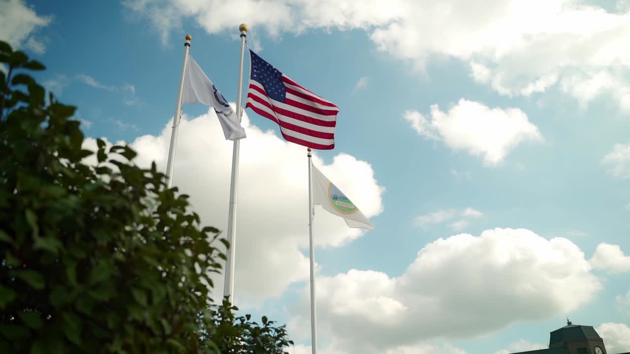 America flag flying outside of city hall on a sunny summer day