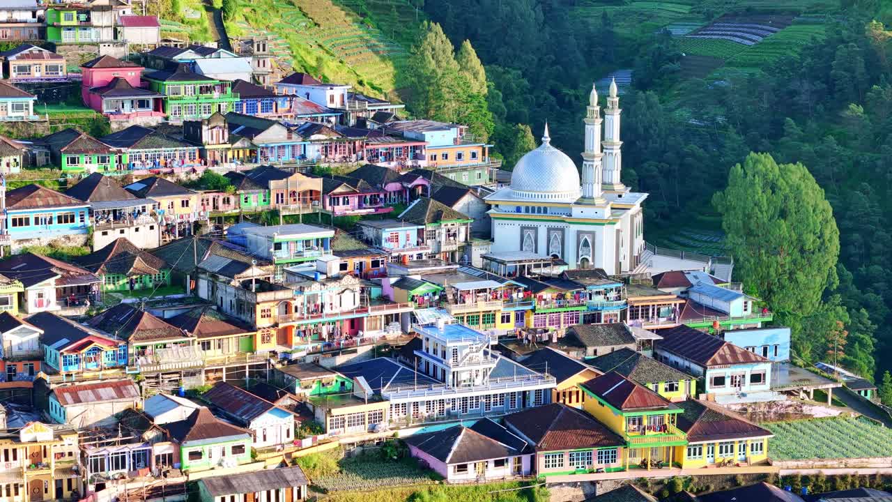 Beautiful aerial scenery of a colorful hillside village in the Mount Sumbing, Indonesia. Showing dense houses, green landscape, and local architecture