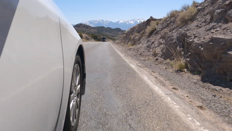 front right wheel of a car driving on the road in eureka, utah, usa