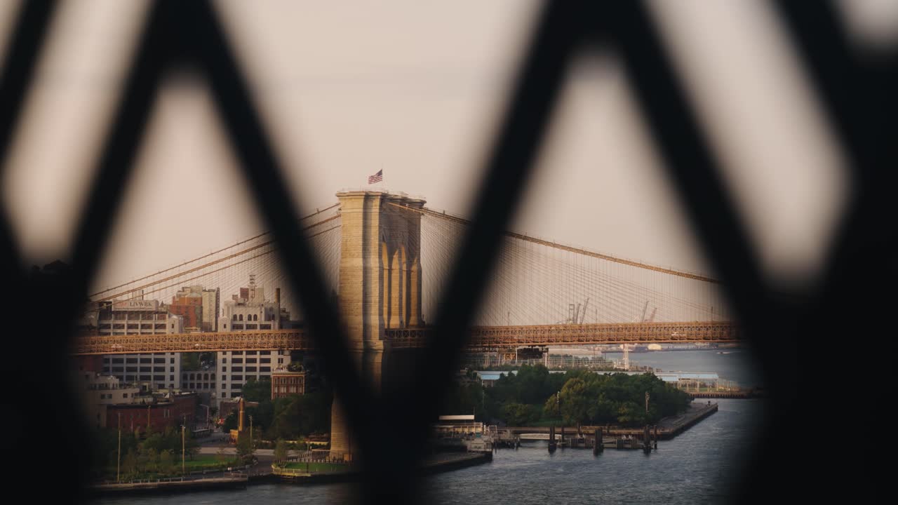 Cinematic short of Brooklyn bridge seen from fence on a sunny day, New York, USA