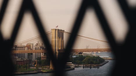 cinematic short of brooklyn bridge seen from fence on a sunny day, new york, usa