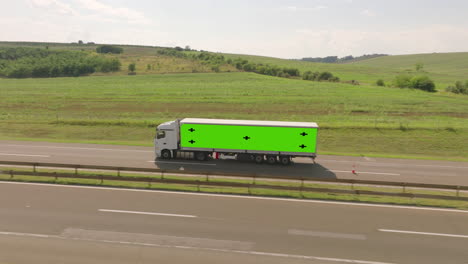 truck on highway with green screen trailer