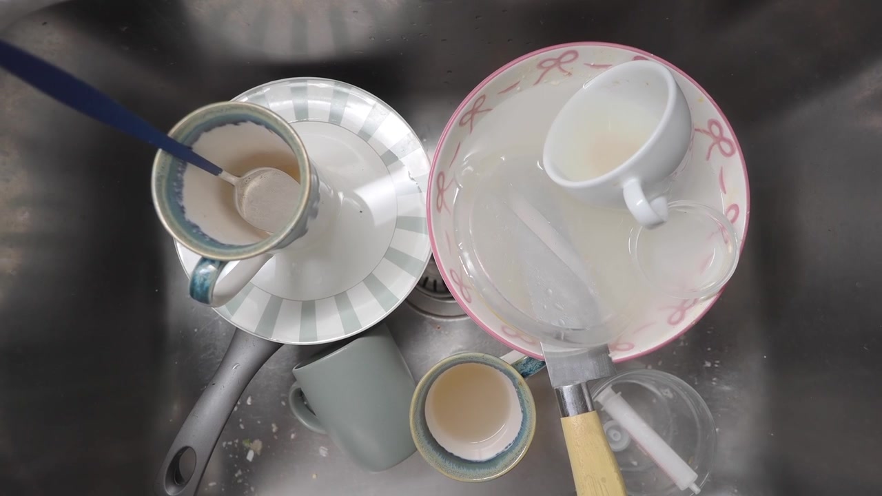 Dirty Dishes Soaking in a Kitchen Sink