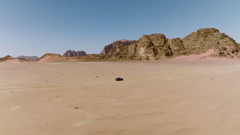 car exploring in wilderness at wadi rum desert in jordan