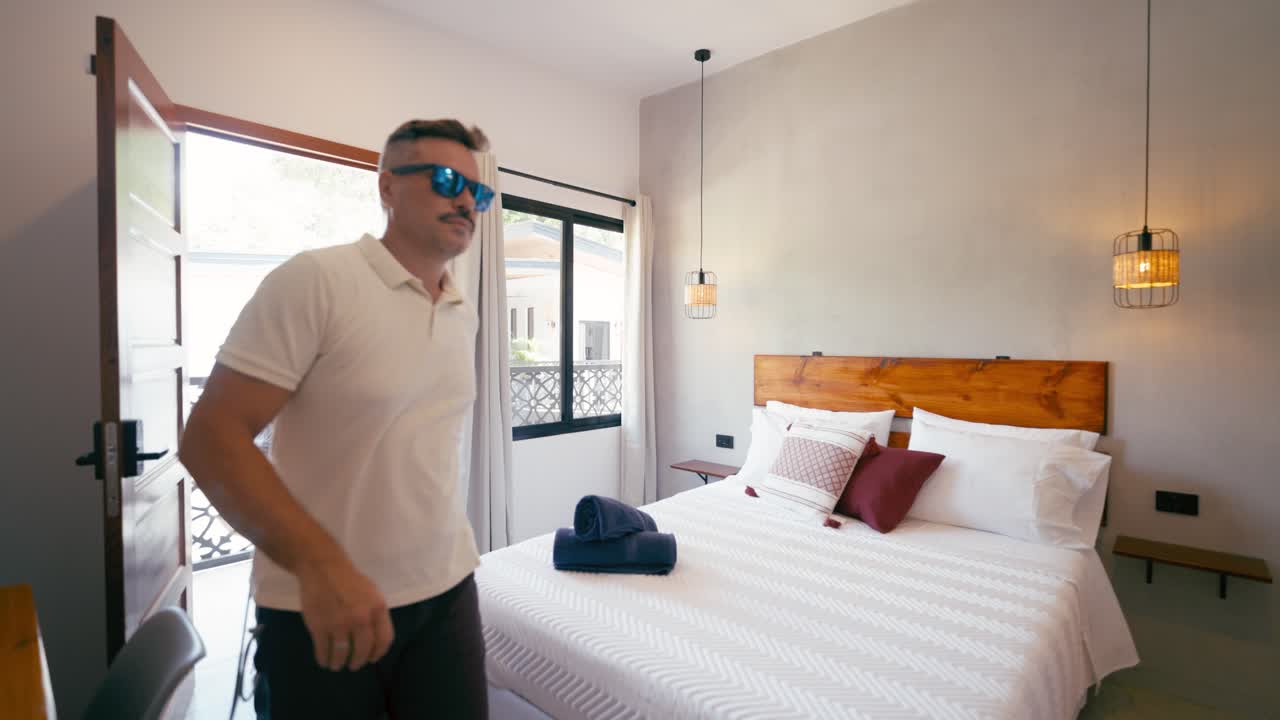 Couple Arriving and Entering a Modern Hotel Room with Luggage