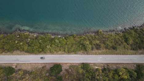 aerial view of a road by a lakeside