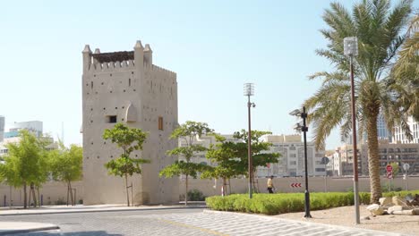 Al-Fahidi-Historical-in-Dubai,-UAE---The-Stunning-Scenery-Of-The-Beautiful-Historic-Buildings-With-Green-Green-and-Bright-Blue-Sky-Above---Wide-Shot