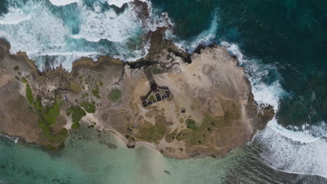 aerial view of a remote island with an old lighthouse