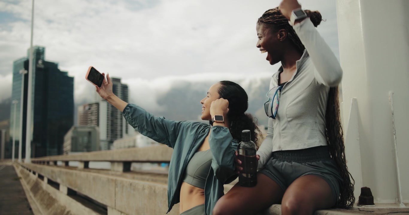 Two Young Women Taking a Selfie Together After a Workout