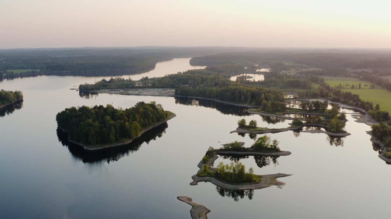Volo su un fiume al tramonto. Ripresa aerea con drone di un fiume con piccole isole.