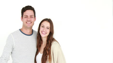 Happy-couple-smiling-at-camera-and-embracing