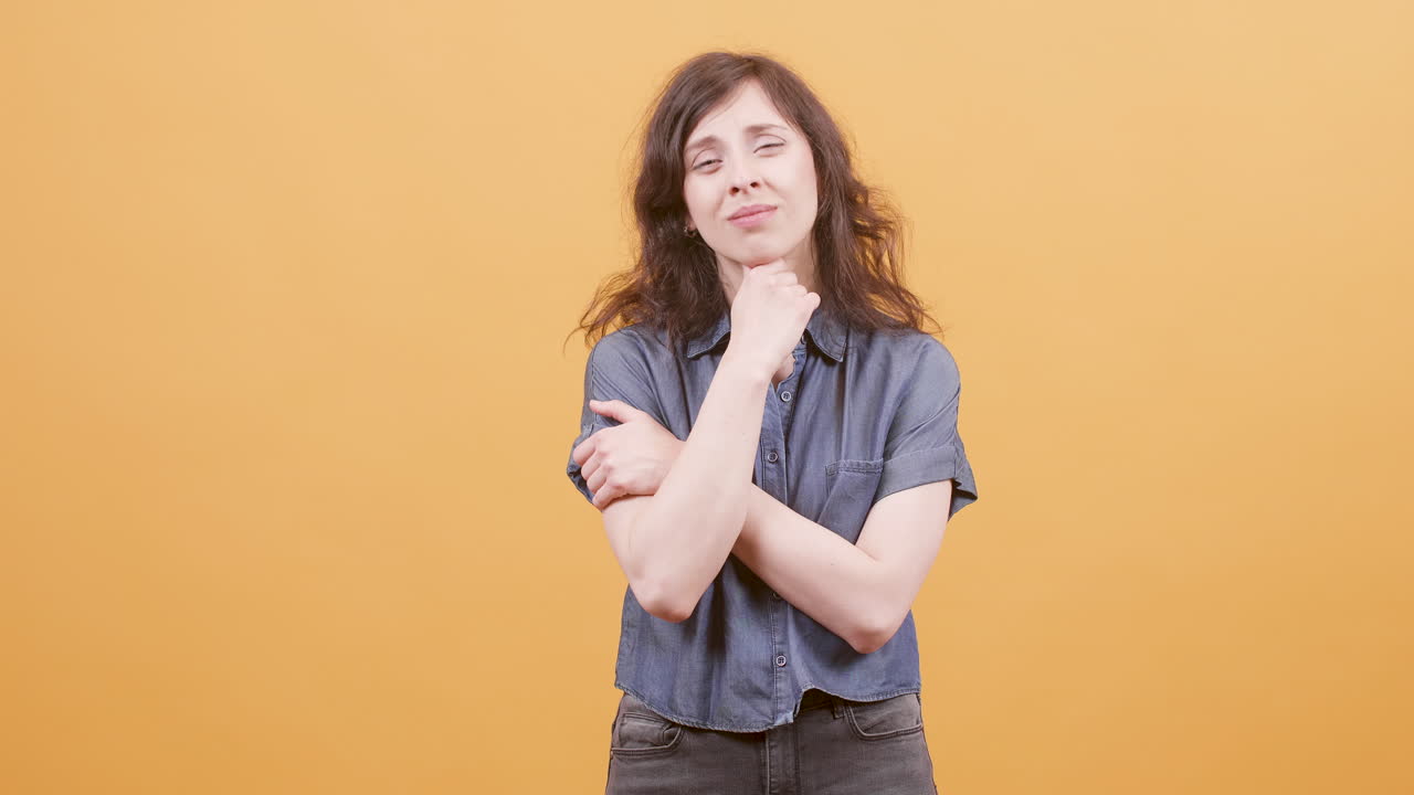 Woman in blue shirt looking thoughtful