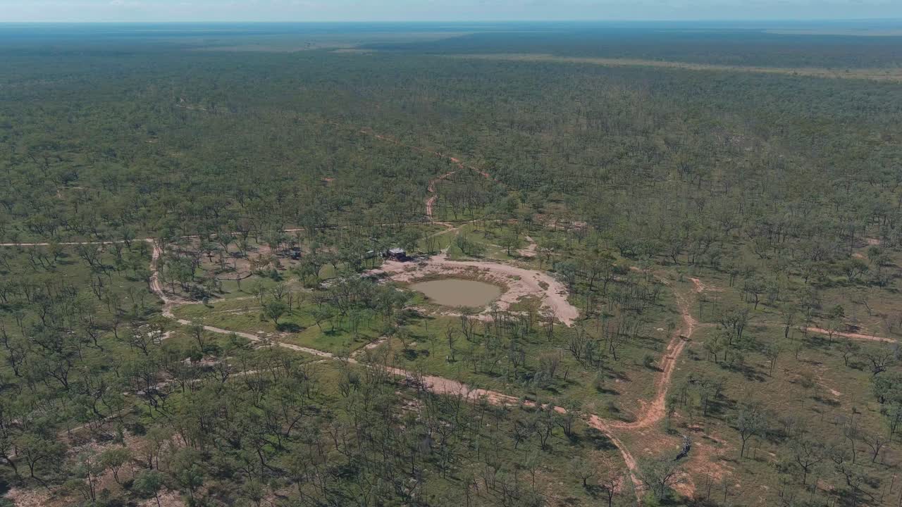 A dam full of water in the middle of a remote outback cattle station