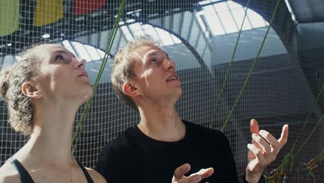 couple looking up at something in an indoor climbing gym