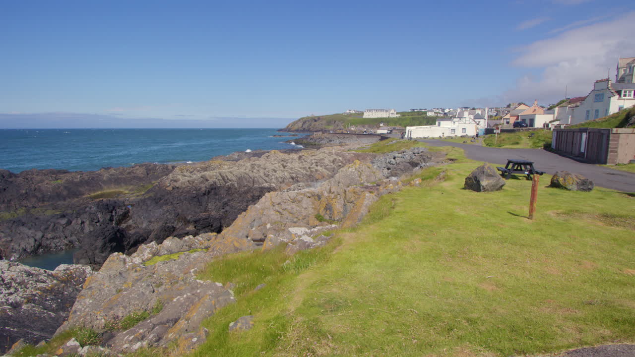 Extra Wide shot looking down Dunskey Street, south cress of the rocky coastline with portPatrick in background