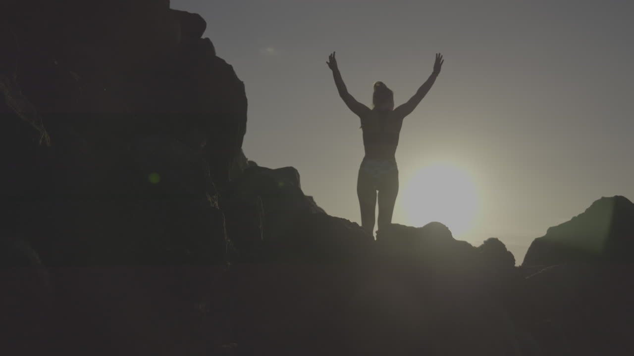 Woman on Rocks at Sunset