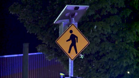 pedestrian crosswalk sign at night w police lights