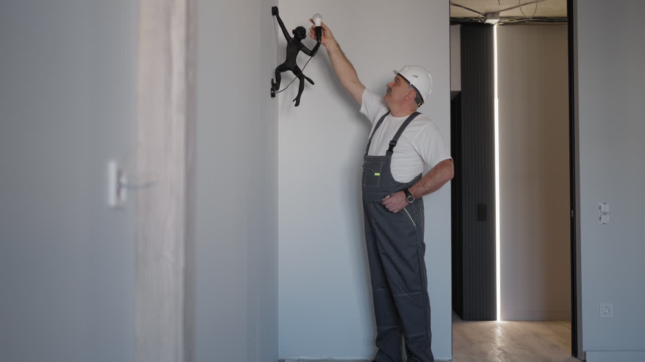 Plumber checks the operation of the faucet and shower head in the bath