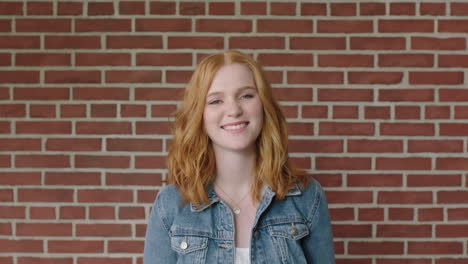 portrait-of-beautiful-red-head-woman-smiling-cheerful-feeling-optimistic-student-indoors