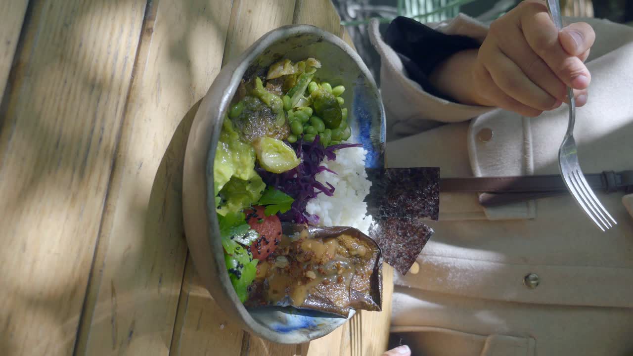 A bowl of healthy food with rice, vegetables and some meat