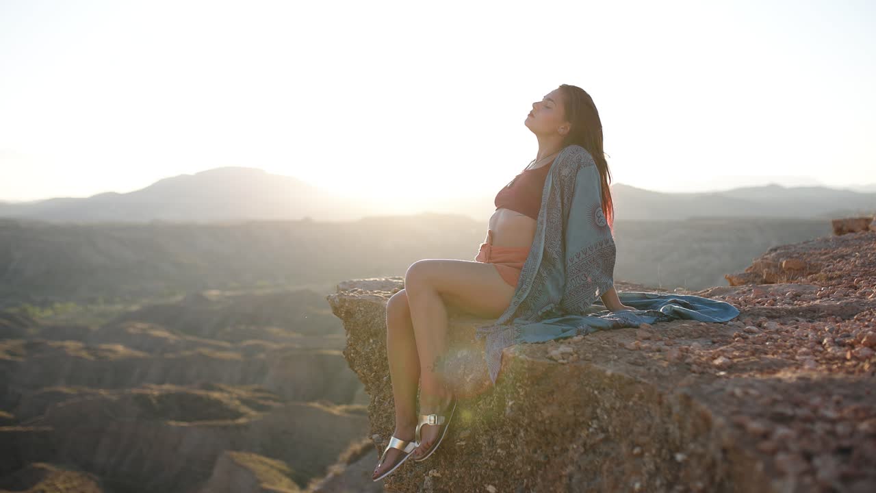 Woman Enjoying Sunset on a Desert Cliff