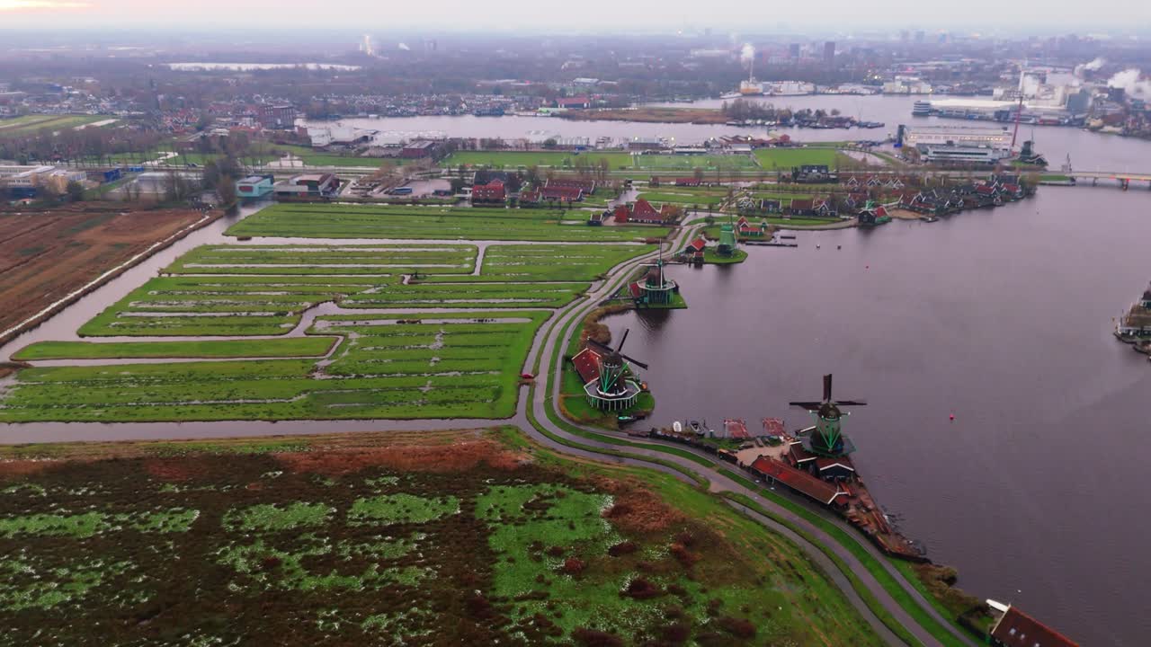 Dronevideo of the Windmills of zaanse schans (close to Amsterdam) in the early dawn lights.
