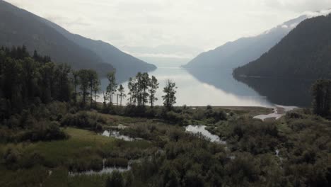 Aerial-dolly-over-the-misty-shoreline-of-Slocan-Lake,-Canada