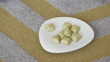 child reaching for mint chocolates on a plate