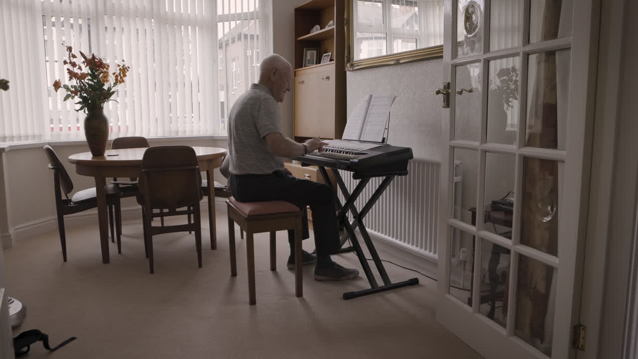 Man playing piano in living room