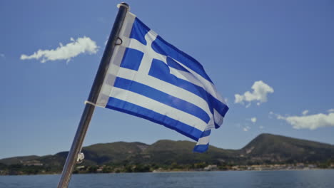 greek national flag flying in breeze in mediterranean islands, slow motion