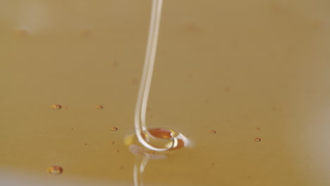 high angle shot of honey flowing into more honey