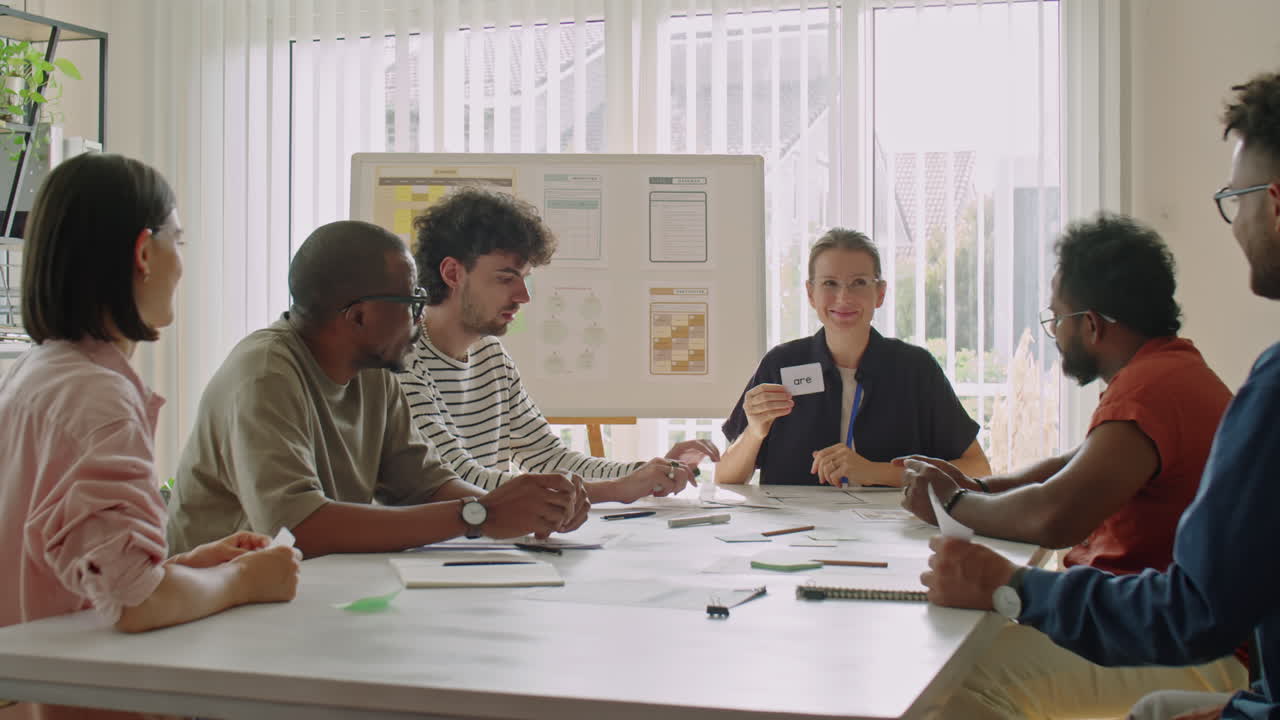 English Teacher Using Word Cards while Giving Lesson to Migrants