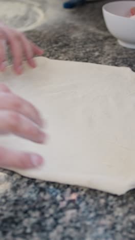thin and round shaped pizza dough prepared by the italian chef
