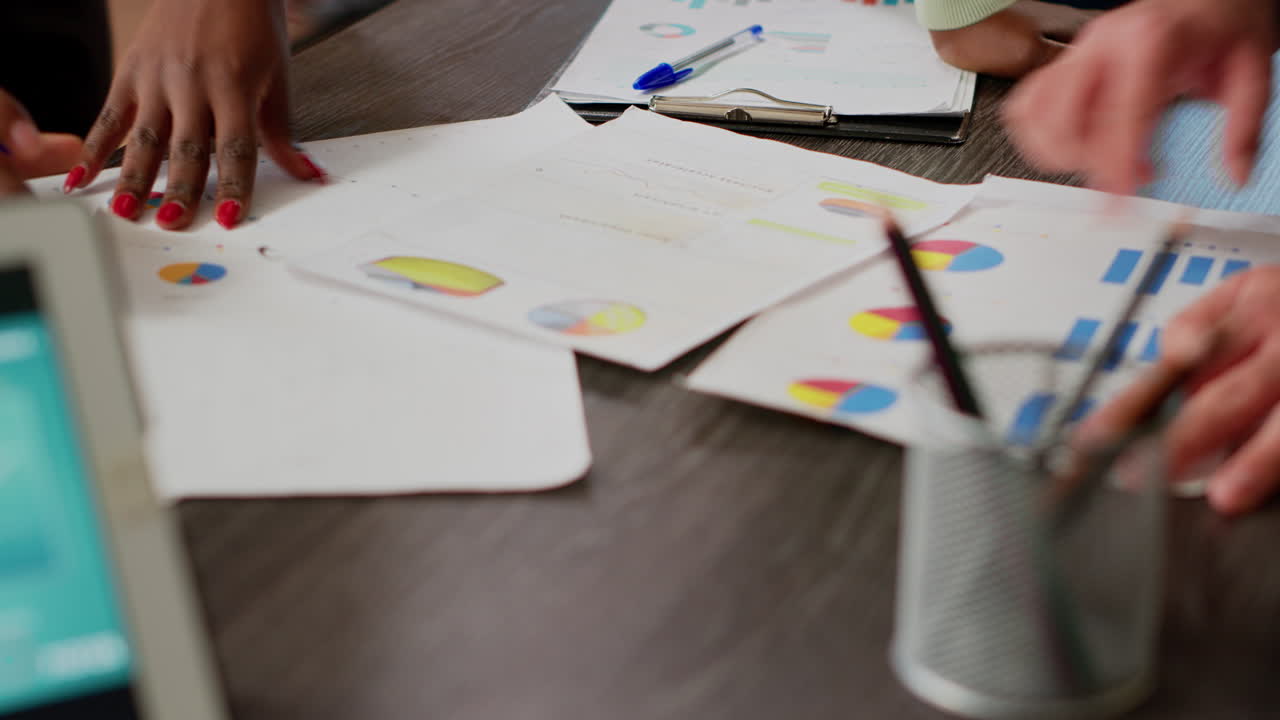 Business people looking at charts and diagrams on documents