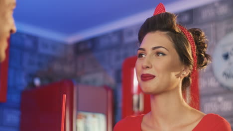 pin up woman talking to her boyfriend in an american diner