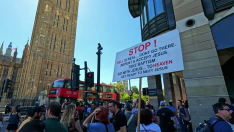 protestor holds religious sign near busy street