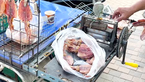 dried squid displayed on a street vendor cart